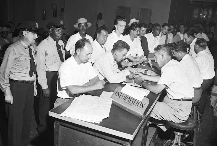 A crowd of veterans wait their turn to get counsel on schooling on the last day to file papers under the G.I. Bill in New York on July 25, 1951. (Bettmann/Getty Images)
