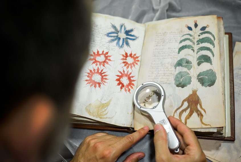 Quality control operator of the Spanish publishing outfit Siloe Luis Miguel works on cloning the illustrated codex hand-written manuscript Voynich in Burgos on August 9, 2016. (Cesar Manso/AFP via Getty)