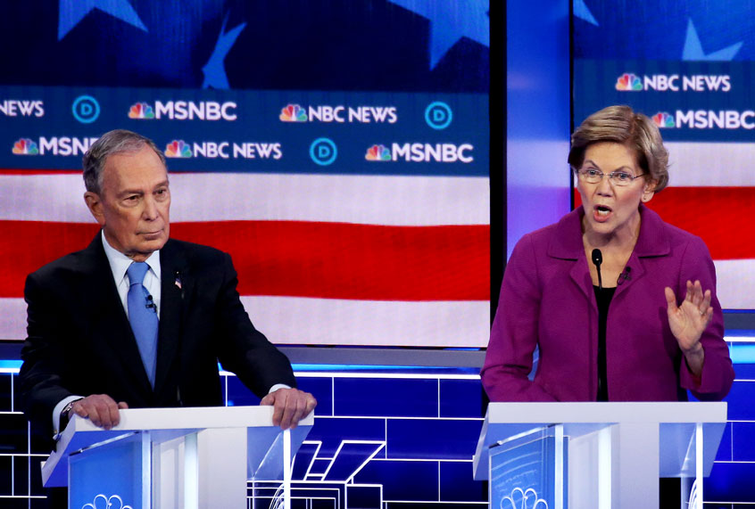 Democratic presidential candidate (L) former New York City Mayor Mike Bloomberg and Sen. Bernie Sanders (I-VT) listen as Sen. Elizabeth Warren (D-MA) speaks during the Democratic presidential primary debate at Paris Las Vegas on February 19, 2020 in Las Vegas, Nevada. Six candidates qualified for the third Democratic presidential primary debate of 2020, which comes just days before the Nevada caucuses on February 22. (Mario Tama/Getty Images)