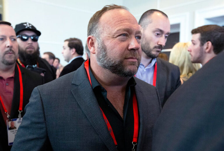 Conspiracy theorist Alex Jones walks at the Conservative Political Action Conference, CPAC 2020, at the National Harbor, in Oxon Hill, Md., Thursday, Feb. 27, 2020. (AP Photo/Jose Luis Magana)
