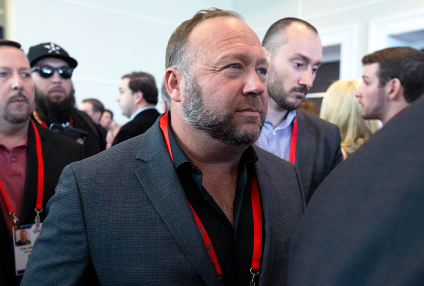 Conspiracy theorist Alex Jones walks at the Conservative Political Action Conference, CPAC 2020, at the National Harbor, in Oxon Hill, Md., Thursday, Feb. 27, 2020. (AP Photo/Jose Luis Magana)
