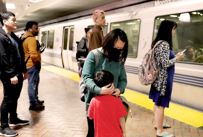 Some commuters opt to wear respiratory masks during the afternoon commute at Montgomery BART station in San Francisco, Calif., on Wednesday, March 4, 2020. On Wednesday, one person became the first victim in California to die from the coronavirus disease. Also, the first two cases in San Francisco were reported the following day. (Ray Chavez/MediaNews Group/The Mercury News via Getty Images)
