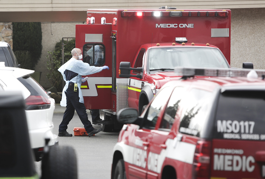 Ambulance staff prepare to transport a patient from the Life Care Center nursing home where some patients have died from COVID-19 in Kirkland, Washington on March 5, 2020. (Jason Redmond / AFP via Getty)