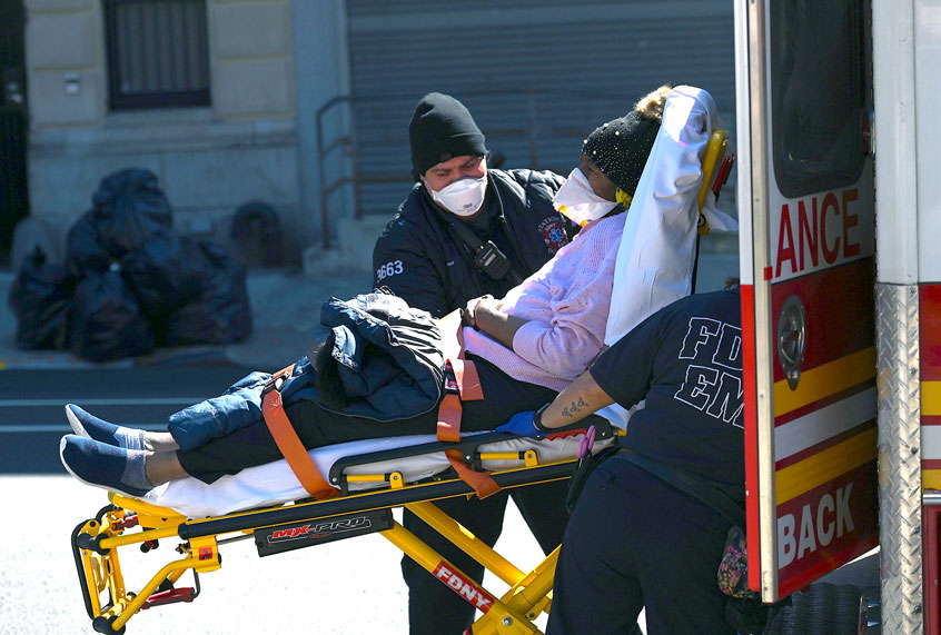 Paramedics carry a stretcher with a patient out of an ambulance at Brooklyn Hospital Center on March 27, 2020 in New York City. (ANGELA WEISS/AFP via Getty Images)