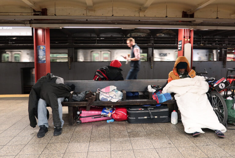 Homeless people sleep in the 42nd St-Bryant Park Subway station on March 9, 2020 in New York City. (Gary Hershorn/Corbis via Getty Images)