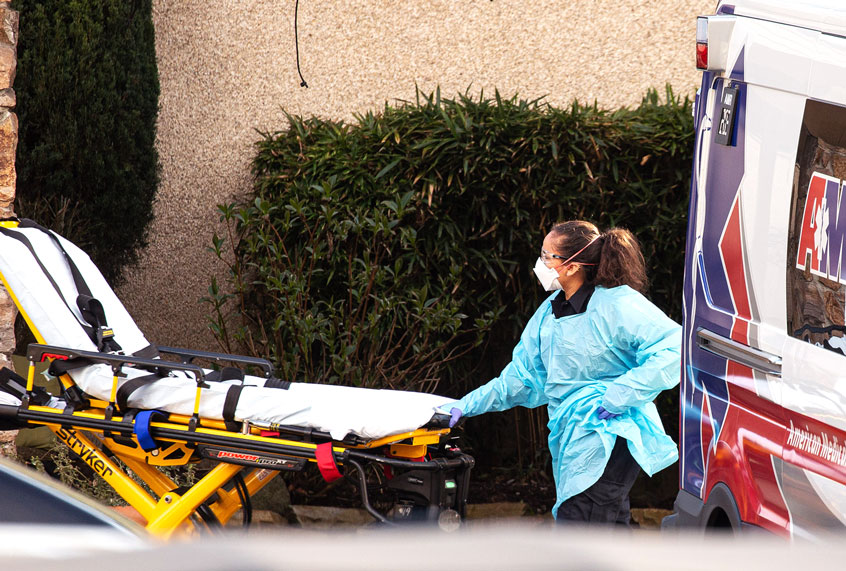 A healthcare worker prepares to transport a patient on a stretcher into an ambulance at Life Care Center of Kirkland on February 29, 2020 in Kirkland, Washington. Dozens of staff and residents at Life Care Center of Kirkland are reportedly exhibiting coronavirus-like symptoms, with two confirmed cases of (COVID-19) associated with the nursing facility reported so far. (David Ryder/Getty Images)
