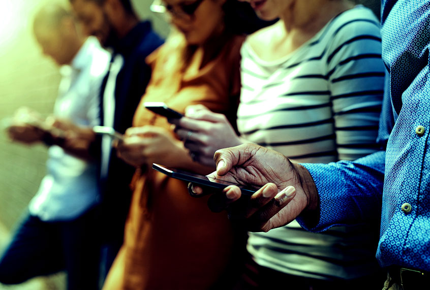 People scrolling through their phones (Getty Images)