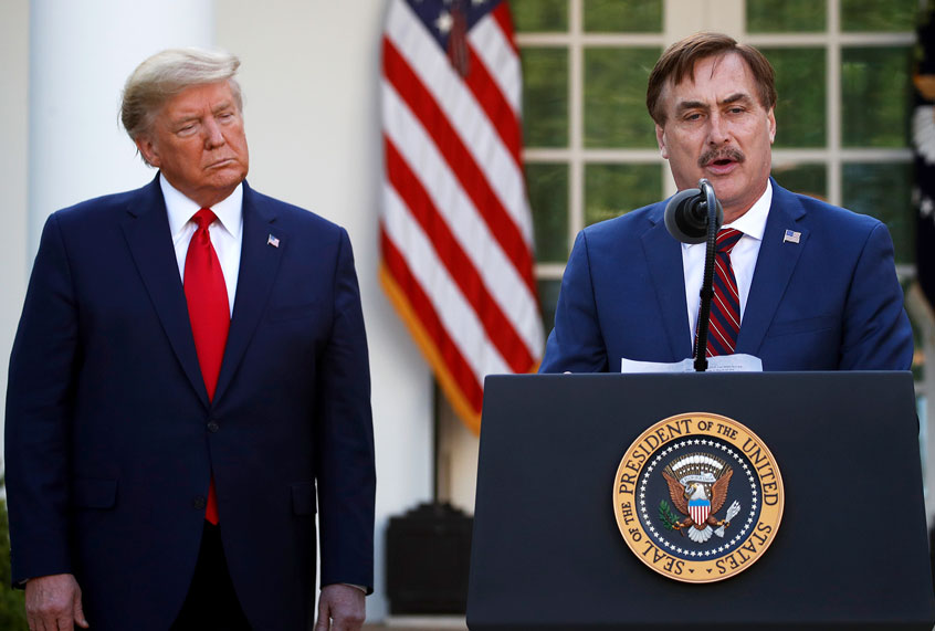 My Pillow CEO Mike Lindell speaks as President Donald Trump listens during a briefing about the coronavirus in the Rose Garden of the White House, Monday, March 30, 2020, in Washington. (AP Photo/Alex Brandon)