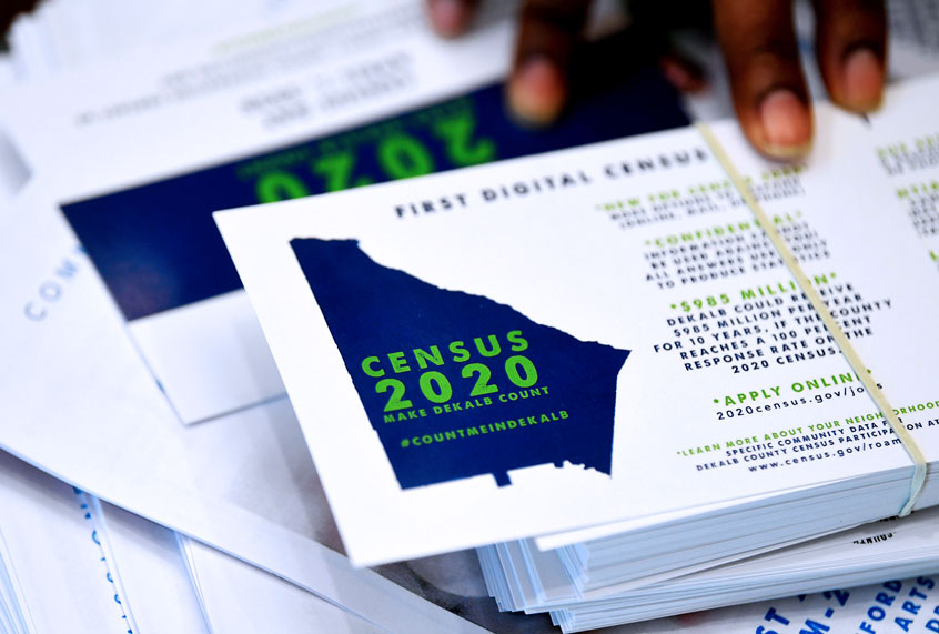 A worker gets ready to pass out instructions on how to fill out the 2020 census during a town hall meeting in Lithonia, Ga. (AP Photo/John Amis)