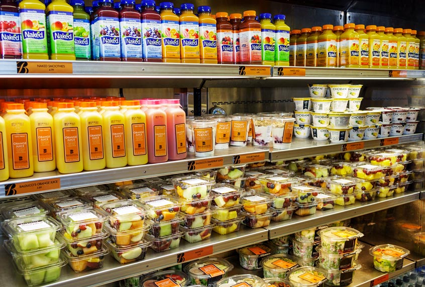 A refrigerated display case of fruit and drinks (Getty Images/Jeffrey Greenberg/Universal Images Group)
