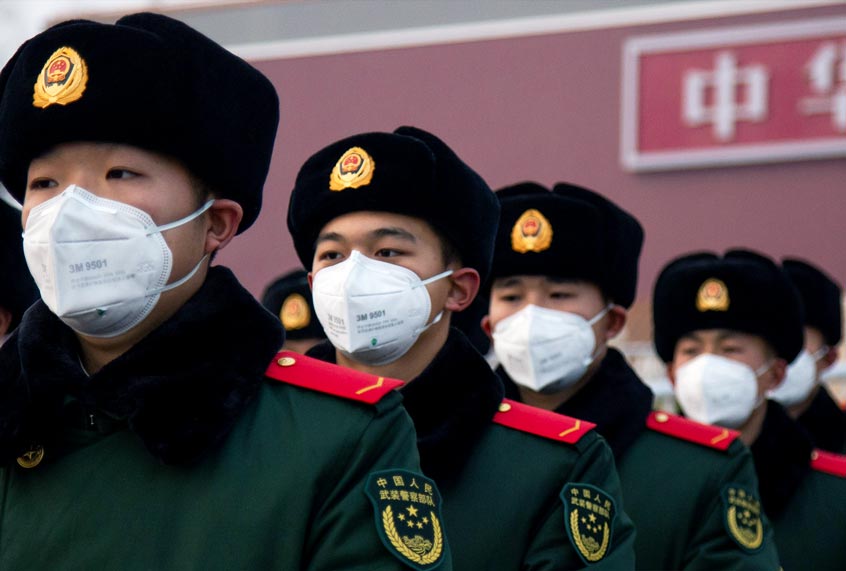 Chinese police officers wearing masks stand in front of the Tiananmen Gate (Betsy Joles/Getty Images)
