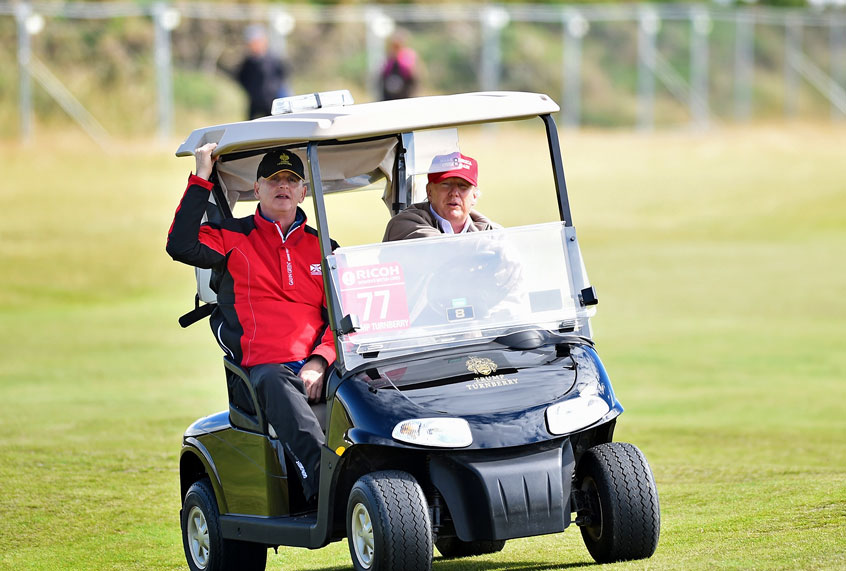 President Donald Trump driving a golf cart (Getty Images)