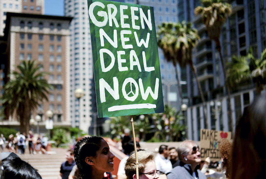 Climate change activists holding signs join in on a rally supporting the "Green New Deal" in Pershing Square in downtown Los Angeles on Friday, May 24, 2019. (AP Photo/Richard Vogel)