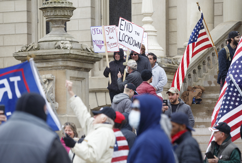 People gather on the Capitol's steps to express their unhappiness with Governor Gretchen Whitmer's Stay Safe, Stay Home executive order on April 15, 2020 in Lansing, Michigan. (Elaine Cromie/Getty Images)