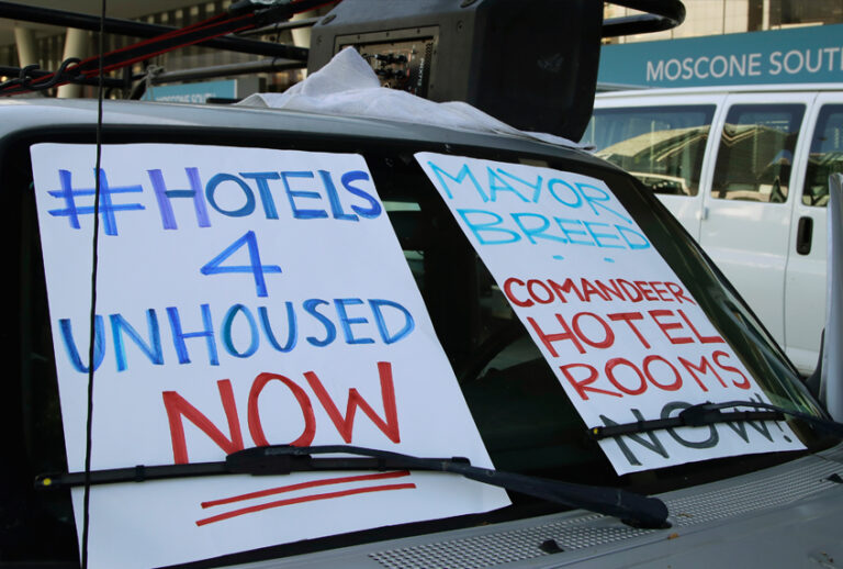 In this April 3, 2020, file photo, activists protest from vehicles outside Moscone Center, asking San Francisco Mayor London Breed to house homeless people using vacant hotels in San Francisco. San Francisco's mayor reported Friday, April 10, 2020, that 70 people at the city's largest homeless shelter have tested positive for COVID-19, infuriating advocates of the homeless who have been pushing the city for weeks to get people out of crowded shelters and into individual hotel rooms. (AP Photo/Ben Margot, File)