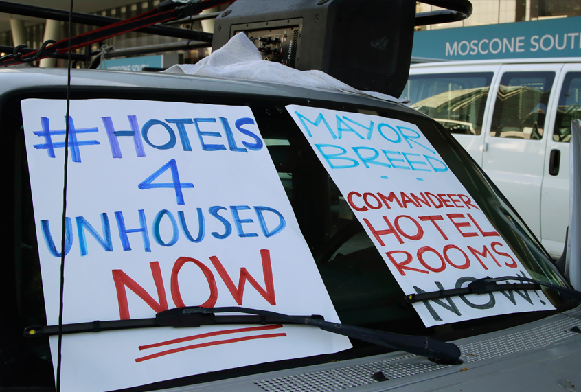 In this April 3, 2020, file photo, activists protest from vehicles outside Moscone Center, asking San Francisco Mayor London Breed to house homeless people using vacant hotels in San Francisco. San Francisco's mayor reported Friday, April 10, 2020, that 70 people at the city's largest homeless shelter have tested positive for COVID-19, infuriating advocates of the homeless who have been pushing the city for weeks to get people out of crowded shelters and into individual hotel rooms. (AP Photo/Ben Margot, File)