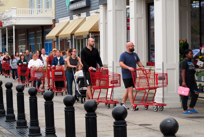 Shoppers seeking to stock up on supplies amid the coronavirus threat line up outside a grocery store in Baton Rouge, La. (AP Photo/Melinda Deslatte)