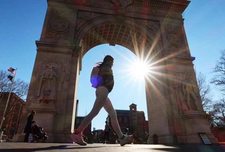 A person walks past the arch in Washington Square Park on March 4, 2020 in New York City. (Gary Hershorn/Corbis via Getty Images)