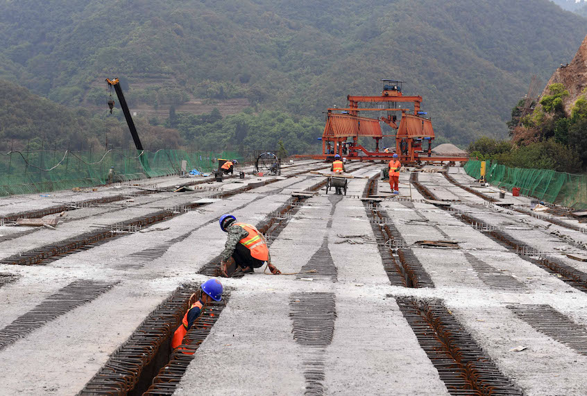 People work at the construction site of Chahe grand bridge of the Kunming-Chuxiong expressway in southwest China's Yunnan Province, April 28, 2020. (Xinhua/Yang Zongyou via Getty Images)