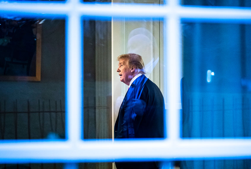 President Donald J. Trump, seen through a window, watches a television in the press office as newscasters talk about him moments after he was speaking with members of the coronavirus task force during a briefing in response to the COVID-19 coronavirus pandemic in the James S. Brady Press Briefing Room at the White House. (Jabin Botsford/The Washington Post via Getty Images)