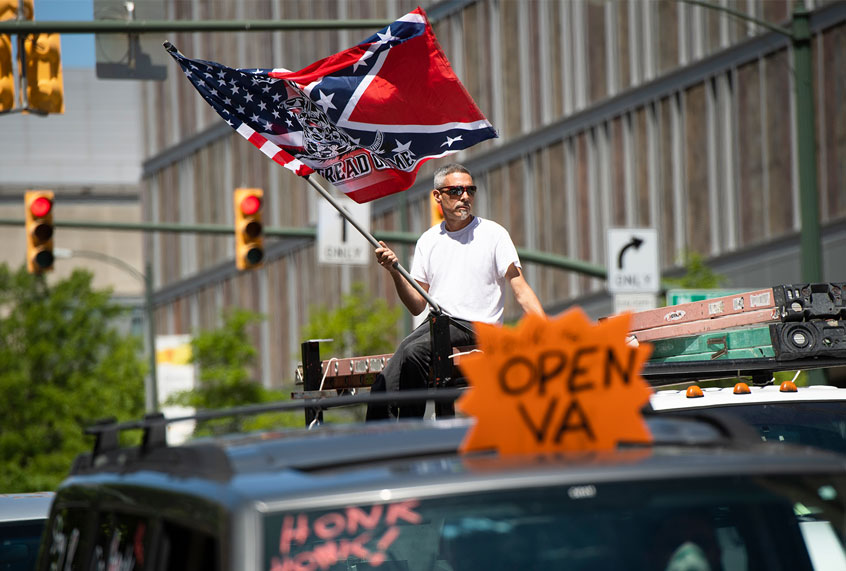 Demonstrators are seen near Capitol Square during a rally to demand that Gov. Ralph Northam (D) lift restrictions that have closed certain businesses in Virginia since the coronavirus outbreak (Tom Williams/CQ-Roll Call, Inc via Getty Images)