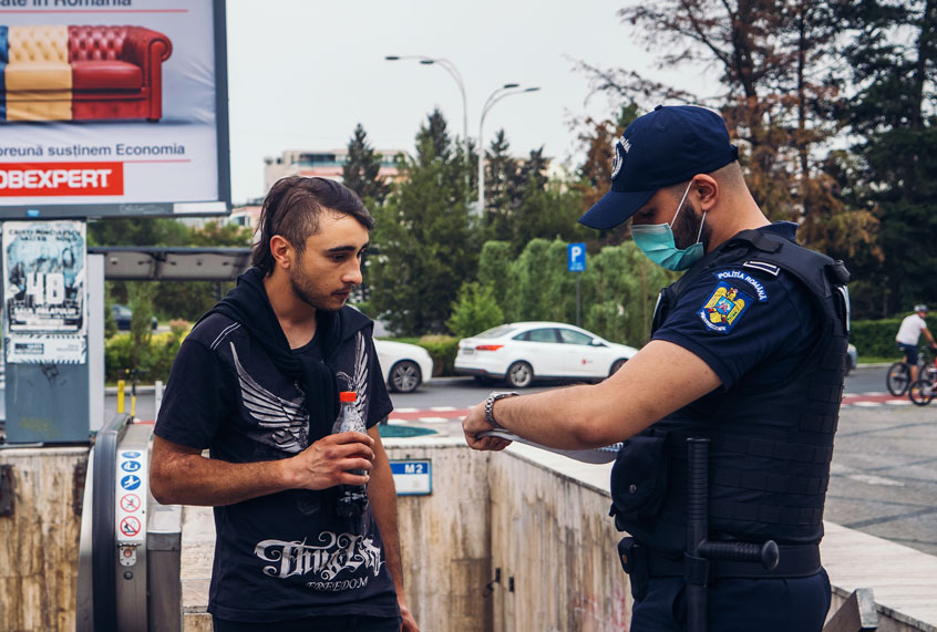 Police officers stop a man who used the subway without a protection mask (ANDREI PUNGOVSCHI/AFP via Getty Images)