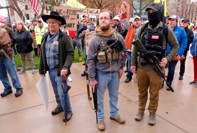 Armed protesters on the steps of the Michigan State Capitol in Lansing, demanding the reopening of businesses (JEFF KOWALSKY/AFP via Getty Images)