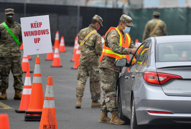A member of the Army National Guard directs a car as it enters a COVID-19 drive-thru testing site on April 20, 2020 in Brooklyn, New York. (Angela Weiss/AFP via Getty)