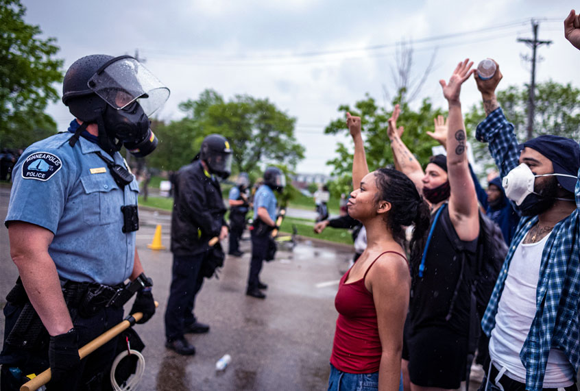 People face off with police near the Minneapolis 3rd Police Precinct. (Richard Tsong-Taatarii/Star Tribune via Getty Images))