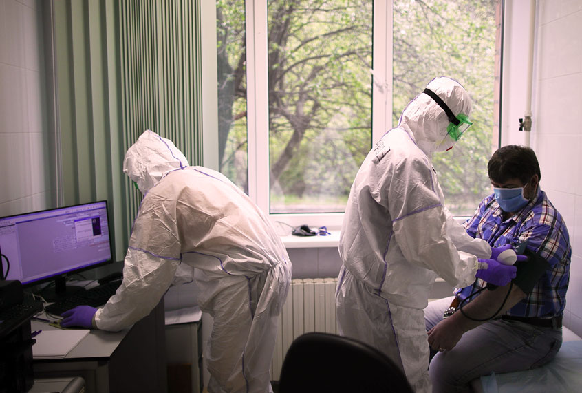 Employees and a patient at the Federal Clinical Center of Higher Medical Technologies of the Russian Federal Medical Biological Agency that treats COVID-19 patients, patients with suspected coronavirus and patients with viral community-acquired pneumonia. (Sergei BobylevTASS via Getty Images)
