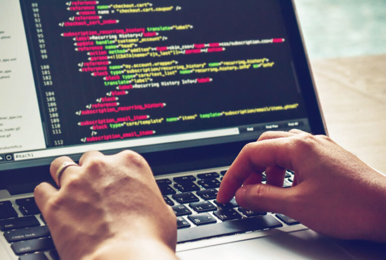 Typing code on a laptop computer (Getty Images)