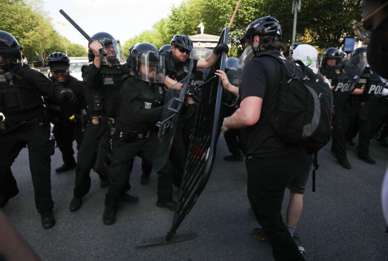 Demonstrators, gathered at Lafayette Park across from the White House, attempt to breach a police barricade during a protest over the death of George Floyd, an unarmed black man who died after being pinned down by a white police officer in Washington, United States on May 30, 2020. (Yasin Ozturk/Anadolu Agency via Getty Images)