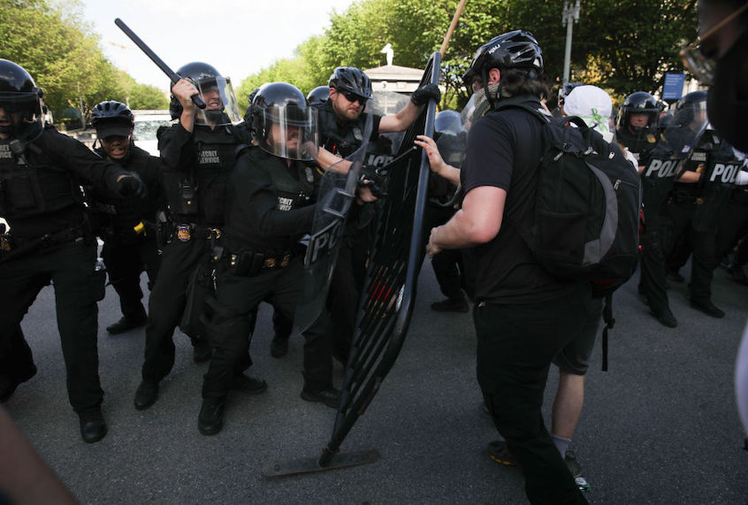 Demonstrators, gathered at Lafayette Park across from the White House, attempt to breach a police barricade during a protest over the death of George Floyd, an unarmed black man who died after being pinned down by a white police officer in Washington, United States on May 30, 2020. (Yasin Ozturk/Anadolu Agency via Getty Images)