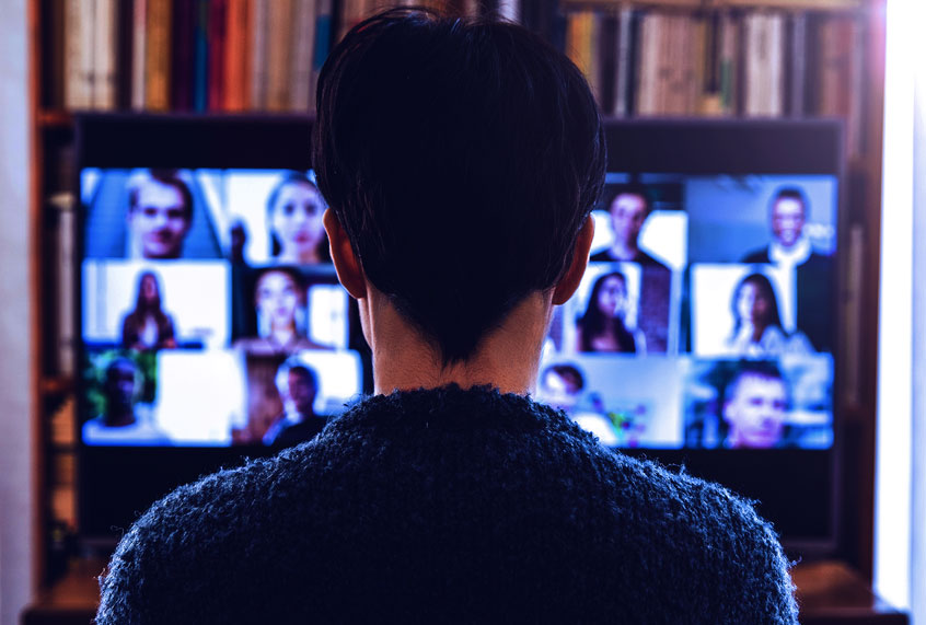 Woman in front of a device screen in video conference (Getty Images)