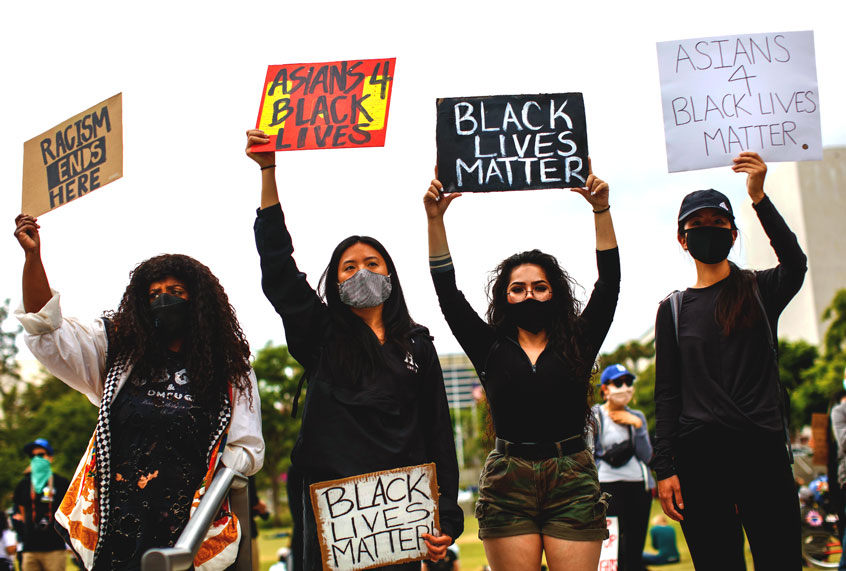 Friends, from left, Sheba Sahlemariam, from Los Angeles, Vicky Van, from San Gabriel, Raven Ramos, from Culver City and Jasmine chow, from San Gabriel, joined nearly 1,000 people gathered to protest the death of George Floyd and in support of Black Lives Matter, in downtown, Los Angeles, CA, on Friday, June 5, 2020. (Jay L. Clendenin / Los Angeles Times via Getty Images)