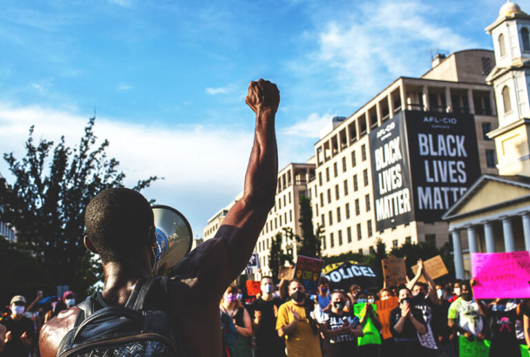 A demonstrator raises his fist at a gathering to celebrate Juneteenth at the 16th street "Black Lives Matter Plaza" near the White House. The US marks the end of slavery by celebrating Juneteenth, with the annual unofficial holiday taking on renewed significance as millions of Americans confront the nation's living legacy of racial injustice. (Probal Rashid/LightRocket via Getty Images)