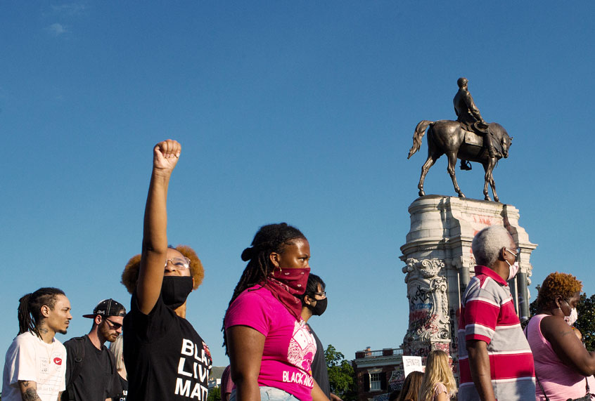 Black Lives Matter activists occupy the traffic circle underneath the statue of Confederate General Robert Lee, now covered in graffiti, on June 13, 2020 at Monument Avenue in Richmond, Virginia. (Andrew Lichtenstein/Corbis via Getty Images)