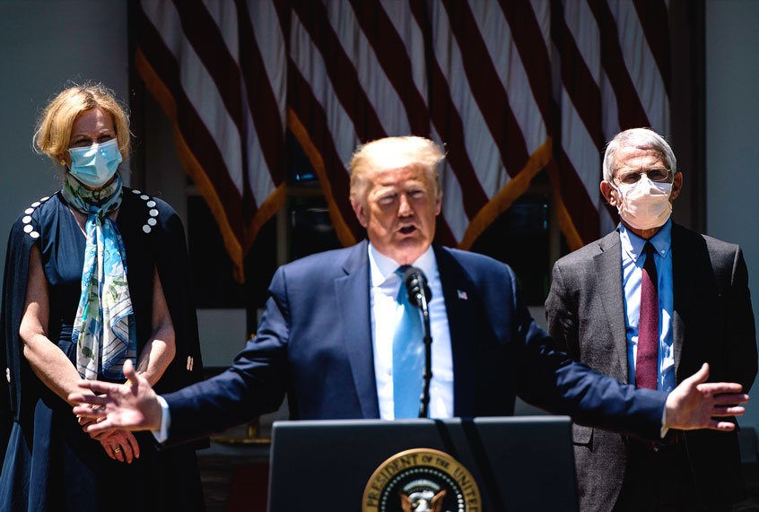 White House coronavirus response coordinator Dr. Deborah Birx, left, and Director of the National Institute of Allergy and Infectious Diseases Dr. Anthony Fauci, both wearing face masks listen as President Donald J. Trump participates in a vaccine development event in the Rose Garden at the White House ( Jabin Botsford/The Washington Post via Getty Images))
