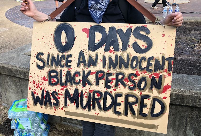 A protester holds up a sign in downtown Louisville, Ky., on June 1, 2020. (Erin Keane/Salon)