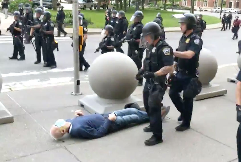 An elderly man is knocked to the ground by two police officers (Twitter/@WBFO)