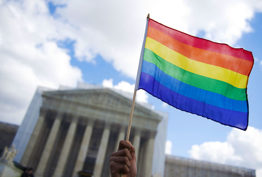 A same-sex marriage supporter waves a rainbow flag in front of the US Supreme Court (Getty Images)