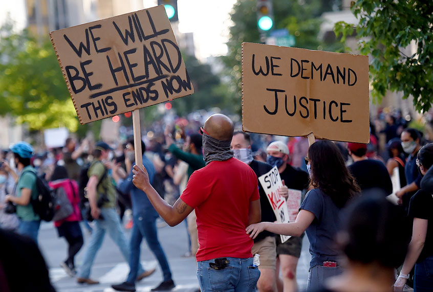 Demonstrators protesting the death of George Floyd hold up placards near the White House on June 1, 2020 in Washington, DC.near the White House on June 1, 2020 in Washington, DC. (OLIVIER DOULIERY/AFP via Getty Images)