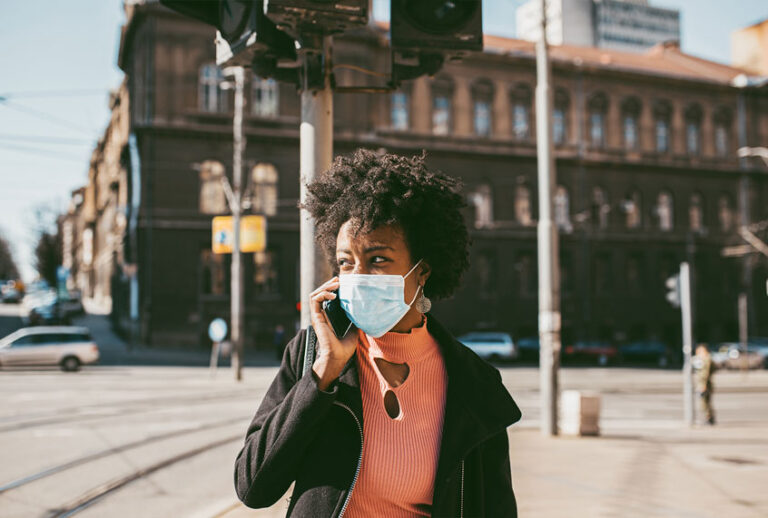 Young Woman With Mask On The Street (Getty Images)