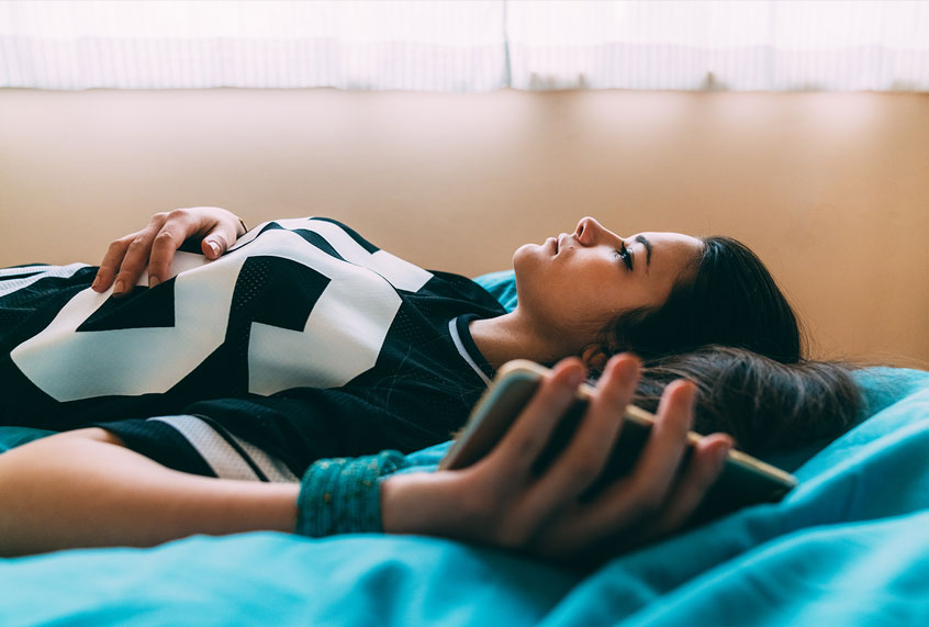 Young woman feeling bored while staying home for safety during a global pandemic (Getty Images)
