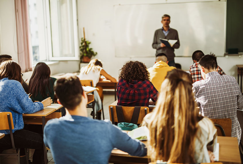 Rear view of large group of students attending a class (Getty Images)