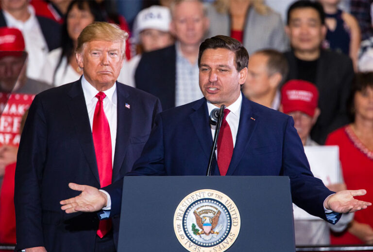 Florida Republican gubernatorial candidate Ron DeSantis speaks with U.S. President Donald Trump at a campaign rally at the Pensacola International Airport on November 3, 2018 in Pensacola, Florida. (Mark Wallheiser/Getty Images)