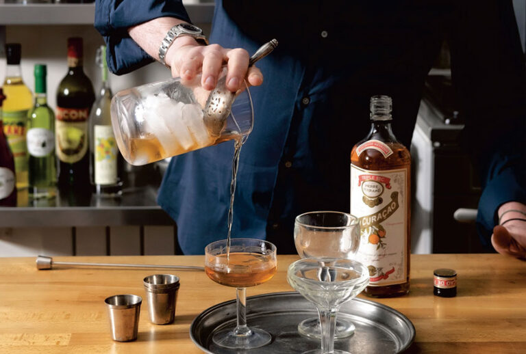 David pouring Curaçao, from Drinking French (Penguin Random House)