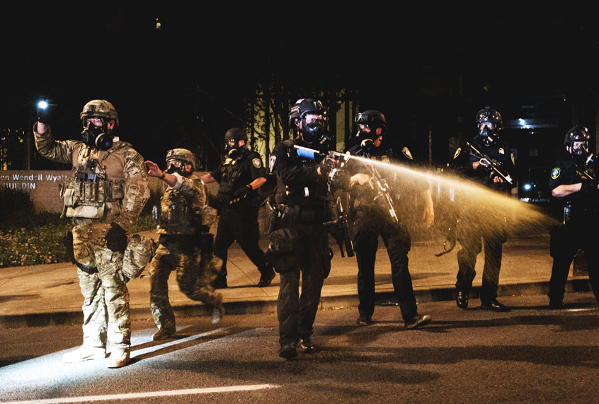 Federal officers use tear gas and other crowd dispersal munitions on protesters outside the Multnomah County Justice Center on July 17, 2020 in Portland, Oregon. Federal law enforcement agencies attempt to intervene as protests continue in Portland. (Mason Trinca/Getty Images)