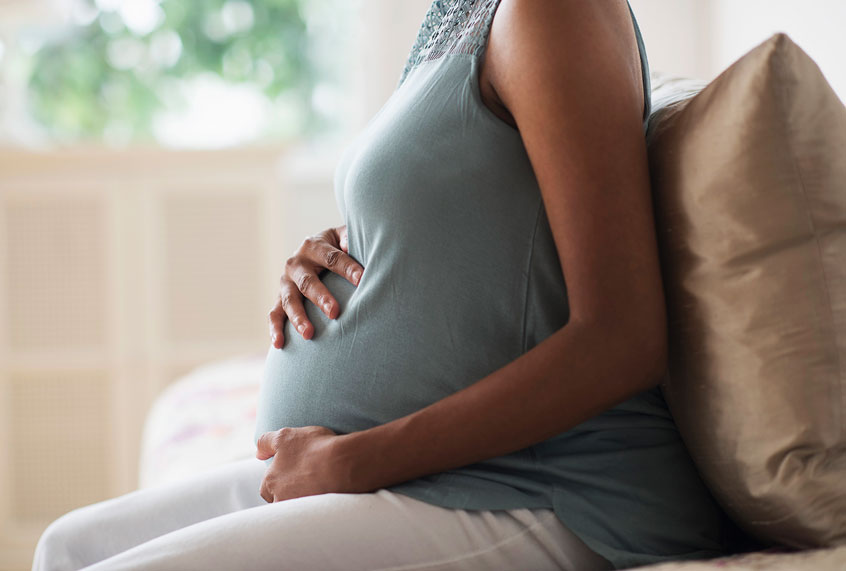 Pregnant mother holding her stomach (Getty Images)