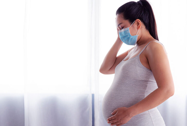 Pregnant Woman Wearing Medical Face Mask (Getty Images)